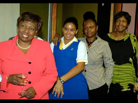 
Four generations from left: Minister Grange; grand-daughter Anastacia Surtese; daughter Paula Surtese;  and mother Raphaelita Walker at the surprise party hosted at her office in April 2009.
