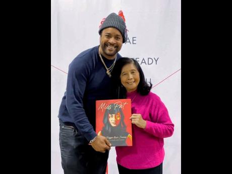 Patricia Chin and Grammy Award-winner reggae artiste, Shaggy hold up a copy of her book, ‘Miss Pat: My Reggae Journey’.