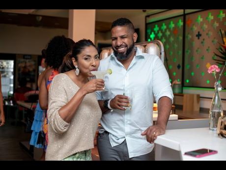 Nicole Pandohie, managing director of Jamaica Food and Drink Kitchen, and Adam Jones, business development executive at GraceKennedy Ltd, enjoyed the celebration and a libation.