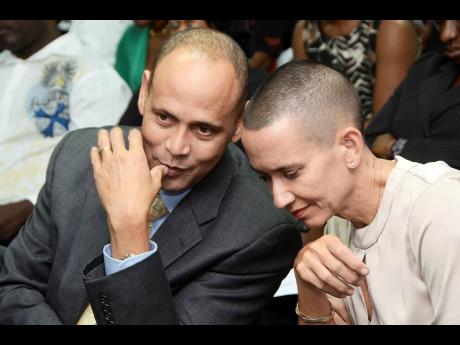 Guradian Life President Eric Hosin chats with Catherine Allen at a company event in New Kingston on April 25, 2012. Allen won a a challenge to unfair dismissal but was rebuked for leaking confidential information.