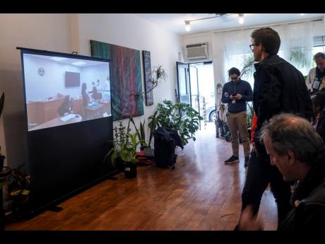 Amazon Labor Union lead organiser Mat Cusick, second from right standing, watches a zoom-cast of vote counting to unionise Amazon warehouse on Staten Island, New York, on March 31, 2022. Cusick is one of two employees Amazon confirmed on Tuesday, May 10, 2