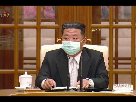 In this image made from video broadcasted by North Korea’s KRT, North Korean leader Kim Jong Un wears a face mask on state television during a meeting acknowledging the country’s first case of COVID-19.