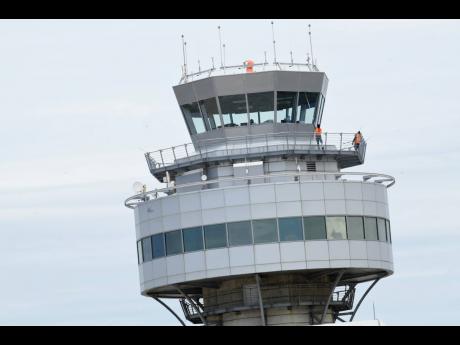 The air traffic control tower at the Norman Manley International Airport stands empty as staff withdrew services on Thursday.