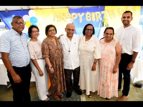 Monsignor Gregory Ramkissoon (centre) with his brother, sisters and nephew, from left: Anand Ramkissoon, Shareeza Ramkissoon, Karen Mohammed, Roma Adam, Carol Sammy and Siddel Ramkissoon at his 70th birthday anniversary Mass of Thanksgiving at Sacred Heart