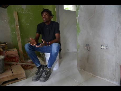 Twenty-two-year-old tiler Gawain Murray speaks of his passion for home-improvement projects in an interview with The Gleaner yesterday. 