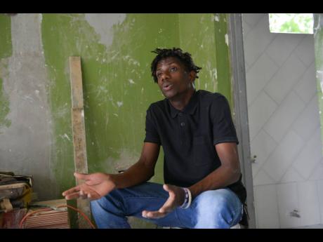 Twenty-two-year-old tiler Gawain Murray speaks of his passion for home-improvement projects in an interview with The Gleaner yesterday. 