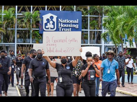 National Housing Trust (NHT) workers are striking at the intersection of Knutsford Blvd and Oxford Road, St. Andrew, on May 13, 2022. University & Allied Workers Union VP Garfield Harvey claims the Finance Ministry is blocking the NHT from increasing worke