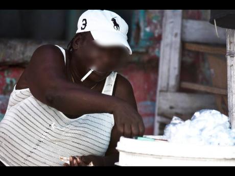 A vendor smoking at her stall.