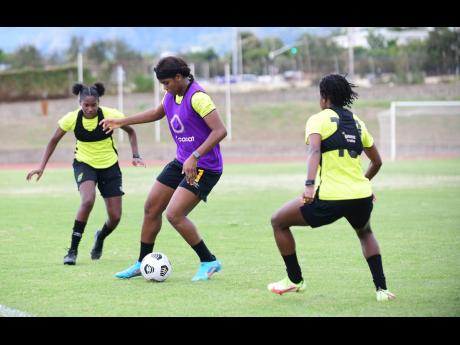 Reggae Girl Khadija Shaw (centre) in action during a training session at the Stadium East field in February.