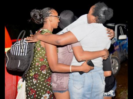 Angenel Powell reunites with her children and their friends  after they were trapped on an abandoned island and rescued by a JDF helicopter in Porto Bello on Thursday, May 12.
