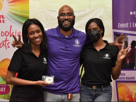Screenshot Jamaica’s boss, Andrew Brown, is flanked by dedicated team members  Shari-Anne Watson (left) and Dessandra Fairclough. They provided patrons with the 360 video experience and sweet selfie cookies.