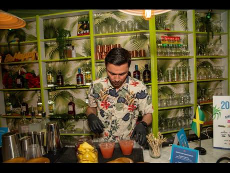 Jasmine’s Caribbean Cuisine bartender Felipe Arango serves up a number of rum cocktails. 