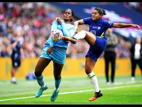 Manchester City’s Jamaican forward Khadija Shaw (left) and Chelsea’s Jessica Carter battle for the ball during the Women’s FA Cup final at Wembley Stadium, London yesterday.