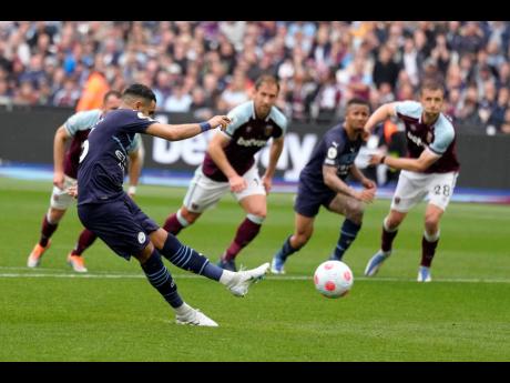 Manchester City’s Riyad Mahrez (left) takes a penalty during the English Premier League match between West Ham United and Manchester City at London stadium , The penalty was saved by West Ham’s goalkeeper Lukasz Fabianski.