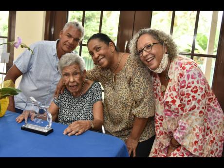 Carmen Robertson Brown (second left) is surrounded by her family: Michael Forrester (left), Marguerite Forrester (second right), and Jean Moss-Solomom during a small tea party held in her honour.