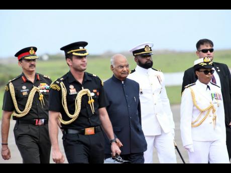 Rear Admiral Antonette Wemyss Gorman (right) escorts Ram Nath Kovind (third left), president of India, shortly after his arrival at the Norman Manley International airport on Sunday.