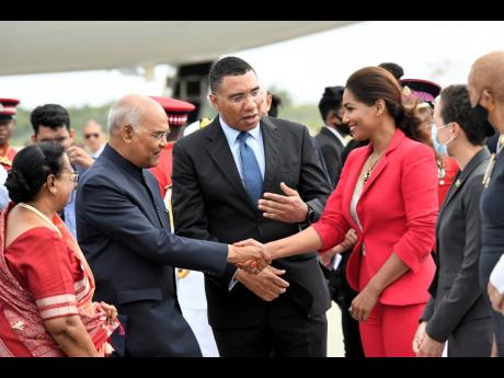 Prime Minister Andrew Holness (centre) introduces Ram Nath Kovind, president of India, and his wife, Savita, to Opposition Spokesperson on Foreign Affairs Lisa Hanna at the Norman Manley International Airport on Sunday. To Hanna’s left are Foreign Minist