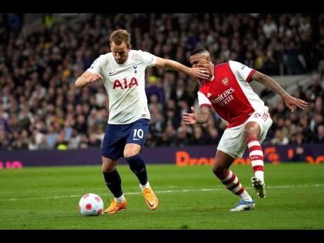 Tottenham’s Harry Kane (left) and Arsenal’s Gabriel vie for the ball during the English Premier League  match between Tottenham Hotspur and Arsenal at Tottenham Hotspur stadium in London last Thursday. Tottenham won 3-0.