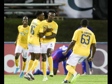 Waterhouse’s Andre Moulton (second right) celebrates with teammates Ky-mani Campbell (second left) and Keithy Simpson (right) after scoring against Arcahaie FC of Haiti in a Group B match in the FLOW Concacaf Caribbean Club Championships on Sunday in the