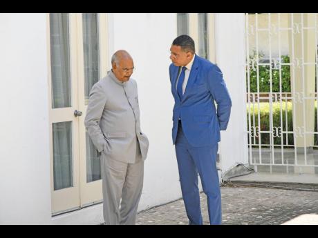 President of India, Ram Nath Kovind (left), has a private conversation with Prime Minister Andrew Holness before the signing of a memorandum of understanding between both countries at Jamaica House on Monday.