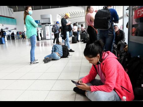 Stranded travellers at the Norman Manley International Airport in Kingston as a result of industrial action by air traffic controllers  on Thursday, May 12. 