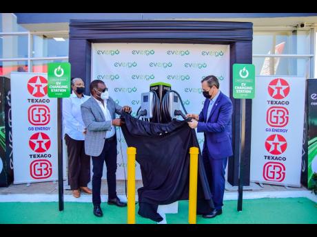 Evergo Jamaica CEO Wayne McKenzie (left) and his GB-Energy counterpart, Bela Szabo, unveil the Level 2 charging stations at Texaco Ironshore in Montego Bay, St James, in February. 