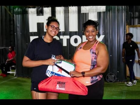 Hard work pays off! After 40 days of frequent exercise and eating in moderation, Cheers to a Dry Lent Challenge second-place winner Isabelle Lewis (left) achieved her weight loss goal. She is awarded her prize by Red Stripe Brand & Corporate PR Manager, St