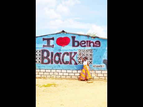 The message of ‘I love being black’ seen on a building  in San Basilio de Palenque, Colombia,  made the perfect backdrop for this iconic photo. 