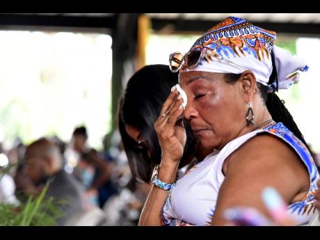 Evanie Henry, common-law wife of the late Donald ‘Tabby Diamond’ Shaw wipes away a the tears as she listened to the tributes at his thanksgiving service last Friday.