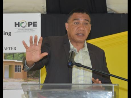 Prime Minister Andrew Holness speaking at a handing over ceremony for a house constructed under the Government’s New Social Housing Programme in Latium, St James, yesterday.