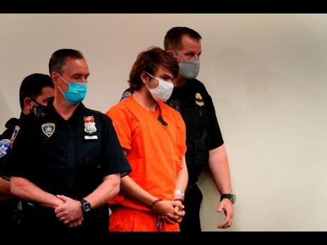 Payton Gendron is led into the courtroom for a hearing at Erie County Court, in Buffalo, N.Y. Gendron faces charges in the May 14, fatal shooting at a supermarket.