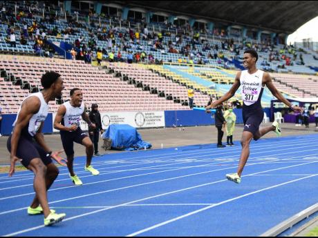 
J’Voughnn Blake (right) of Jamaica College crosses the line anchoring his 4x800m relay team to a win and meet record with a time of 7:24.30 at the Gibson McCook Relays at the National Stadium in February.