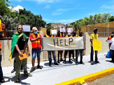 
Firefighters from various stations in the Kingston and St Andrew Division protest outside Gordon House in Kingston on May 17.