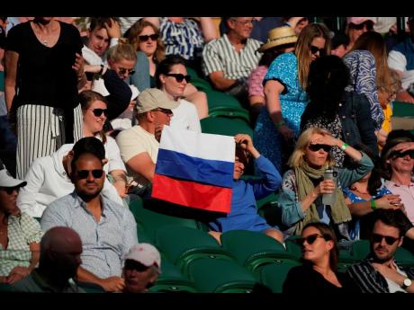 
A spectator holding a Russian flag watches during the men’s singles third round match between Russia’s Daniil Medvedev and Croatia’s Marin Cilic on day six of the Wimbledon Tennis Championships in London last year.