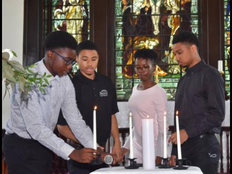 
Credited as a champion of social and economic causes, the four young warriors – Christopher and David Donaldson, Aysha-Simone and Kyle Anthony Brown – each lit a candle, closing an era that saw their grandfather, former Mayor of Montego Bay, Cecil Don