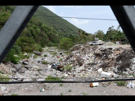 A view of the garbage that is narrowing the path of the Hope River in the vicinity of the Kintyre Bridge.