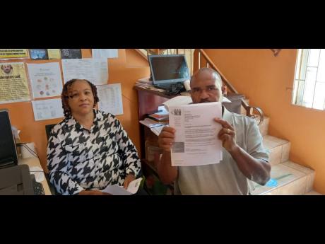 Peter Minott, maintenance manager at Meadowlands Centre of Excellence in May Pen, Clarendon, shows a suspension letter sent to the institution by the HEART/NSTA Trust, citing several breaches at the Bushy Park-based facility. The breaches, he and his direc