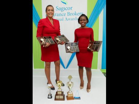 Runner-up for the Annualised Premium Income (API) Trophy and Agent of the Year award Karen-Ann Phillips (left) shows off her many wins alongside her personal assistant Tracy-Ann White as they dazzle in red.