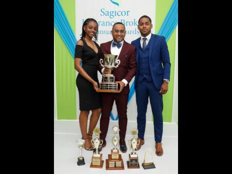 Top adviser Cleon Walchie (centre), who walked away with the most awards, including Agent of the Year, shared the moment with his children Jade and Tyreke Walchie.