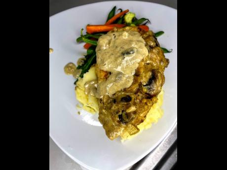 It’s a twist on the famous Italian Marsala that food lovers dream of. Creamy chicken breast on a bed of creamy mashed potatoes and steamed vegetables.