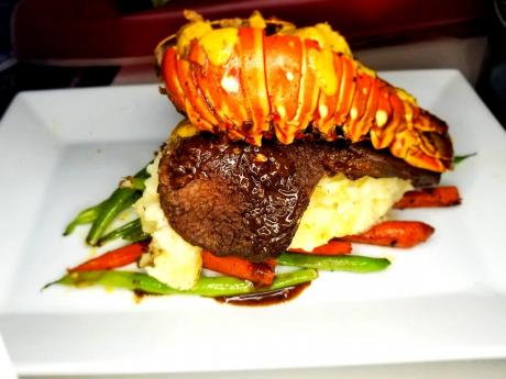 Shadz Surf and Turf: stuffed lobster tail with cream-based sauce on top of pan-seared steak, creamy mashed potatoes and steamed vegetables.
