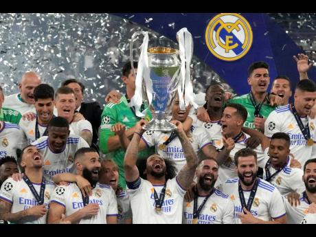 
Real Madrid’s Marcelo lifts the trophy as players celebrate winning the Champions League final soccer match between Liverpool and Real Madrid at the Stade de France in Saint Denis near Paris on Saturday.