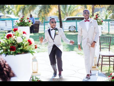 In true performative fashion, the dapper groom (left) dances his way up the aisle alongside his best man. 