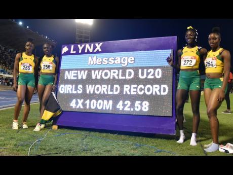 Jamaica’s girls’ Under-20 4x100m relay team celebrates what was then considered a World-Record run of 42.58 during the Carifta Games at the National Stadium on Sunday April 17, 2022. From left are Tina Clayton, Serena Cole, Brianna Lyston, and Tia Clay