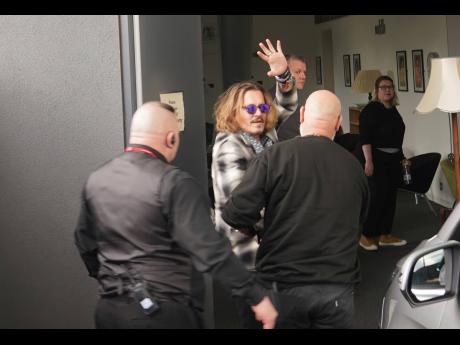 Johnny Depp (second left) arrives at Sage Gateshead, Newcastle, England, where he was due to join Jeff Beck on stage on Thursday.