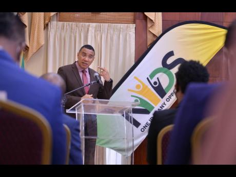 Prime Minister Andrew Holness addressing the audience at a signing ceremony of the memorandum of understanding with deposit-taking institutions for the National Identification System’s pilot of identity verification and authentication services. The cerem