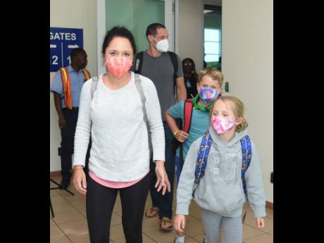 Desiree St Jean, daughter Emree and son Mason arrive at Sangster International Airport in MoBay on the inaugural American Airlines flight from Austin, Texas, on Saturday. Bringing up the rear is dad Robert St Jean.