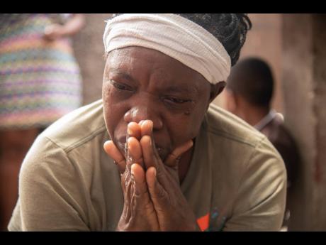Alicia Vernon weeps for her son, Orville Hermit, who was killed on Sunday. 
