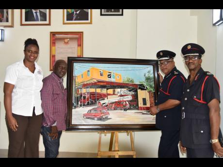 From left: Anna-Kay Fowler, communications officer at Caribbean Community Society; Andrew Duhaney, paint artist; Warren Malcolm, deputy commissioner of the Jamaica Fire Brigade; and Floyd McLean, assistant commissioner with responsibility for Area 4 of the