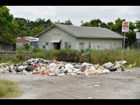 Garbage pile up along Ricketts Street in Savanna-la-Mar, Westmoreland. Like many other sections of the island, the western parish is facing a backlog in garbage collection as the National Solid Waste Management Authority cites resource constraints.